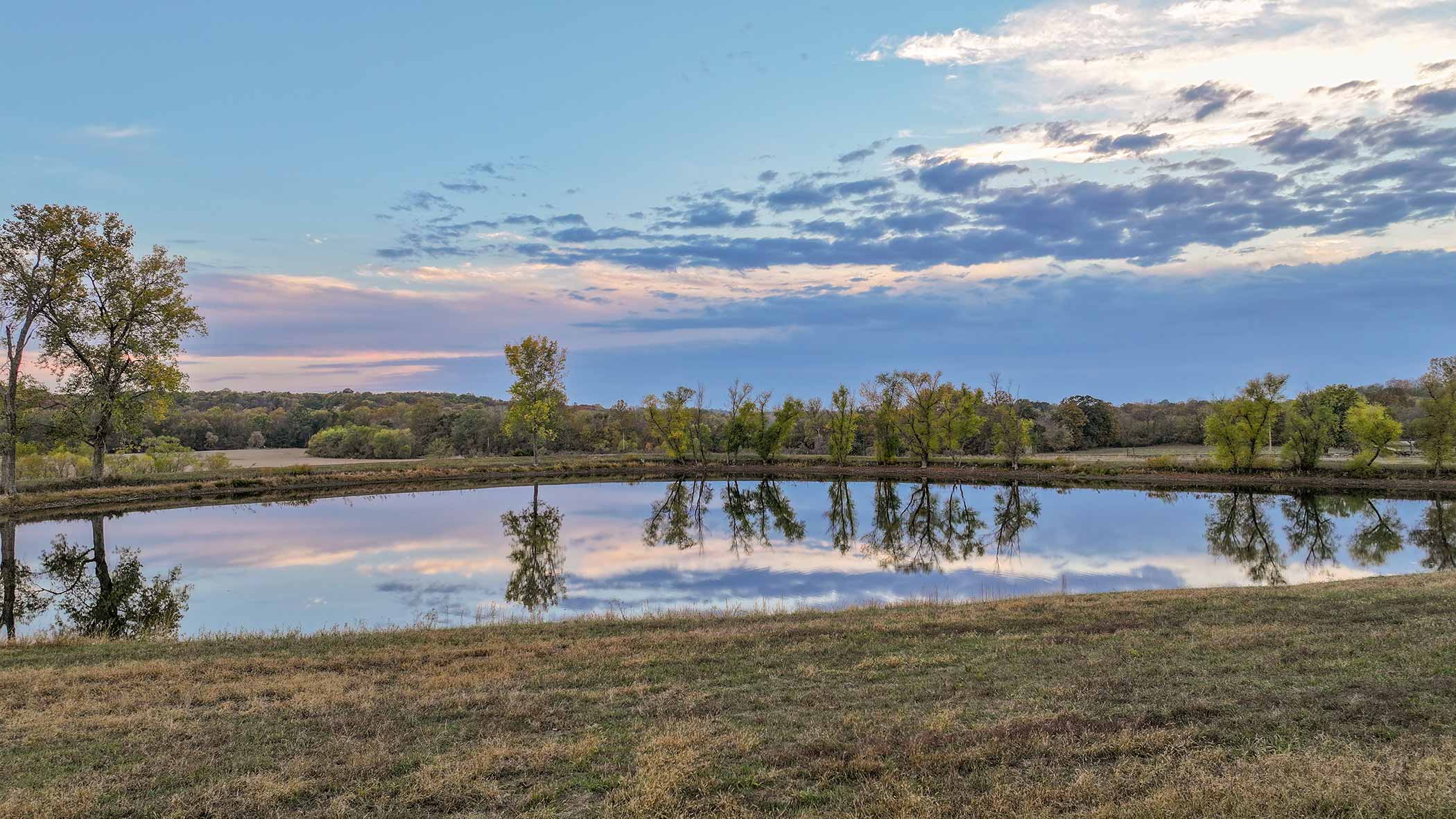 Lake at sunset with perfect mirror reflection