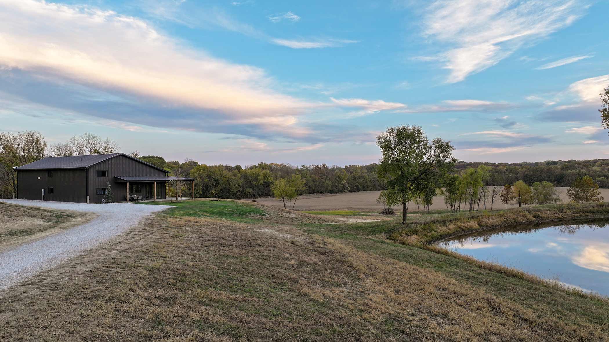 Red Bird Ranch at dusk — lodge and lake in the golden hour light