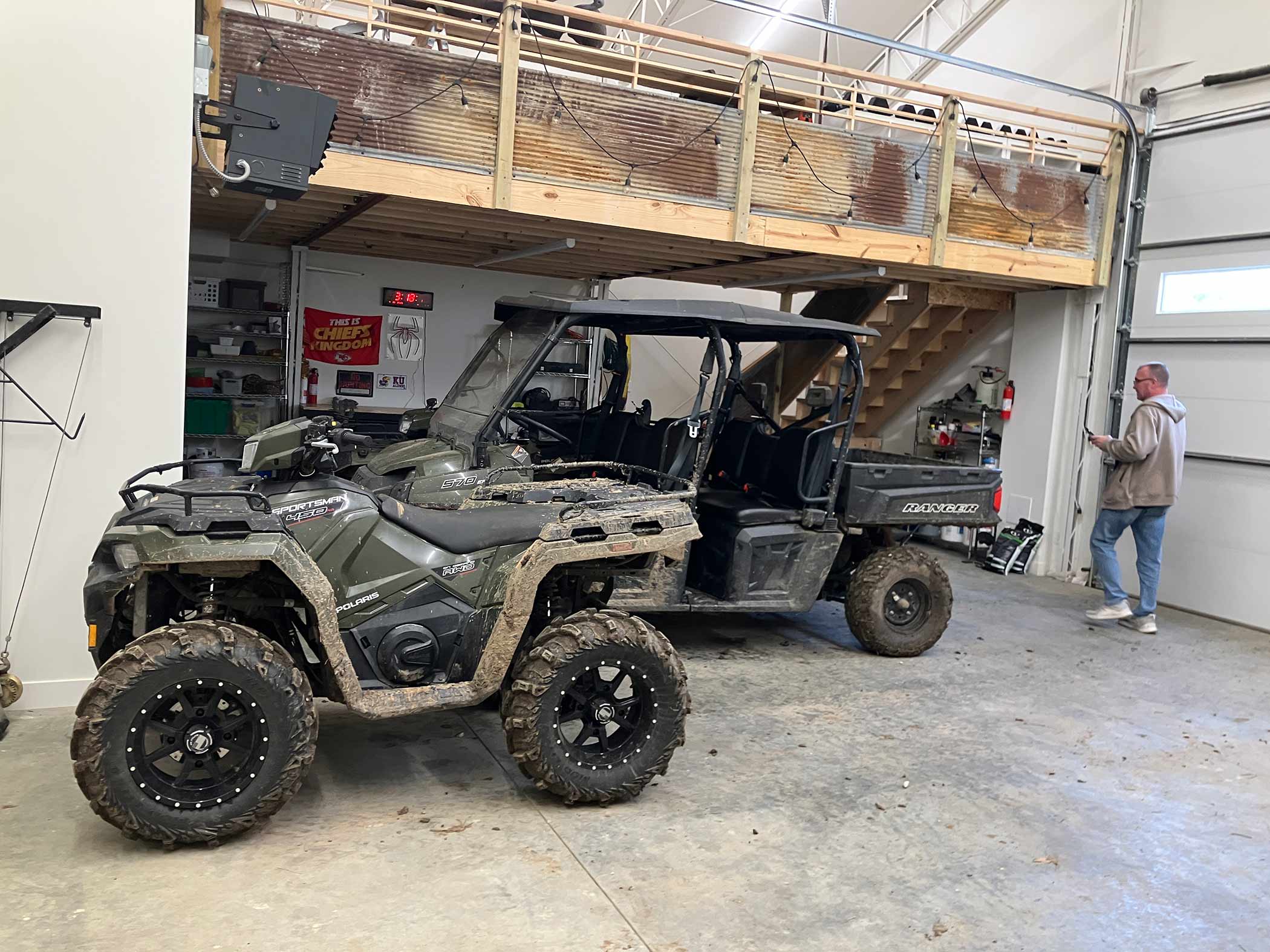 Vehicle garage with Polaris Ranger and Sportsman ATVs in camo