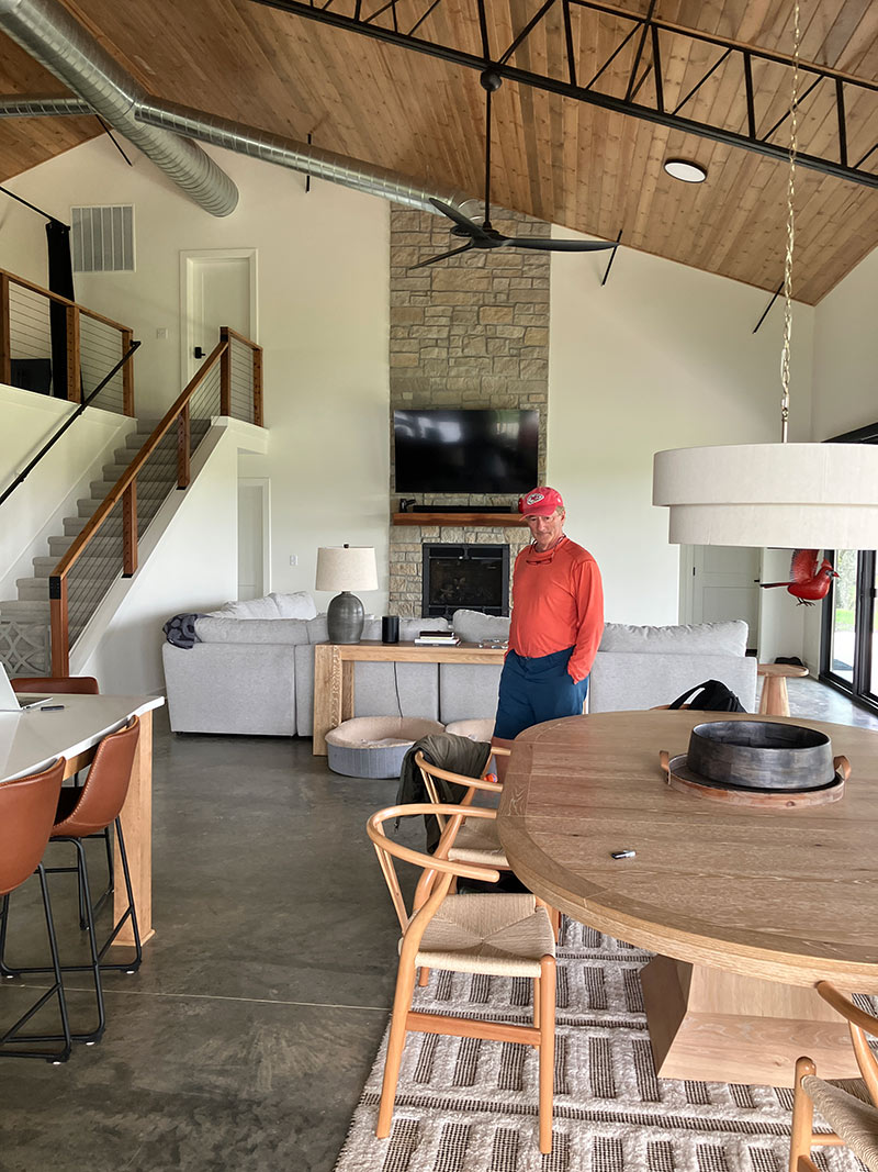 Great room with stone fireplace and vaulted timber ceiling