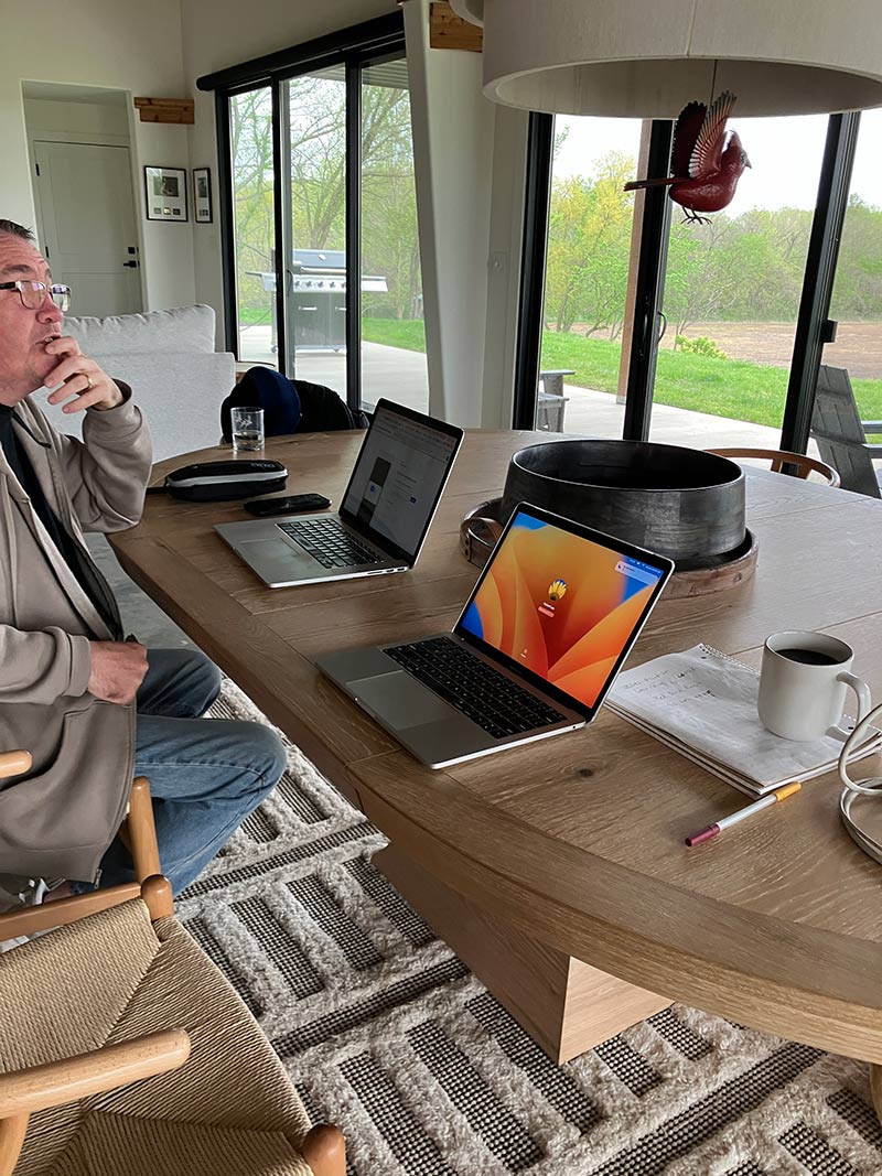 Executive working at Red Bird Ranch with cardinal sculpture visible